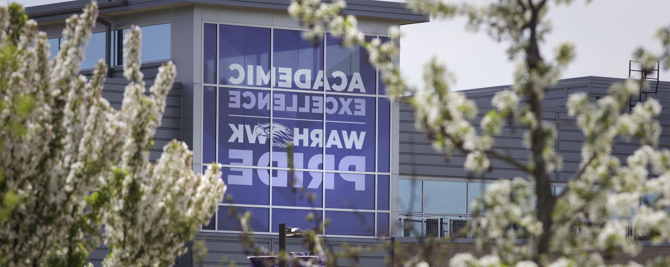 A purple banner on the University Center that says You Belong Here and Academic Pride.