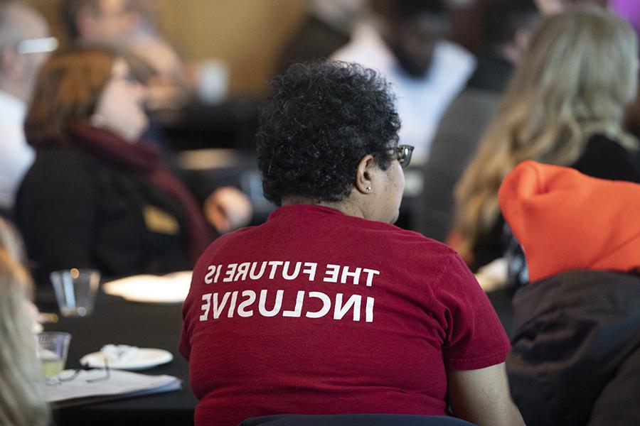 A person wears a shirt that says The Future Is Inclusive.